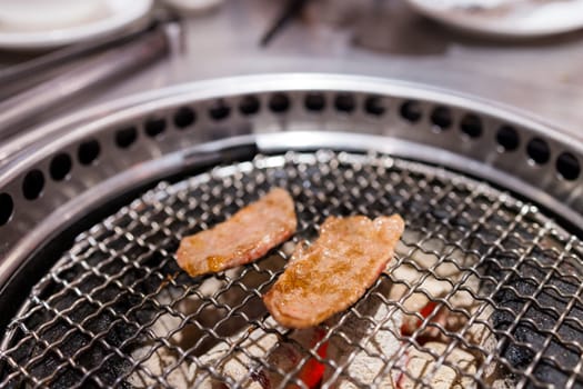 Meats cooked on stove in a japanese yakiniku restaurant