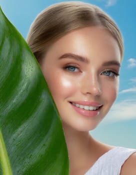Portrait of young beautiful woman with healthy glow perfect smooth skin holds green tropical leaf, look into the hole of colored pink paper. Model with natural nude make up. Fashion, beauty, skincare