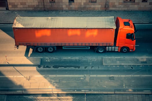 Aerial view an orange truck parked on the side of road, logistic,delivery concept. AI generated