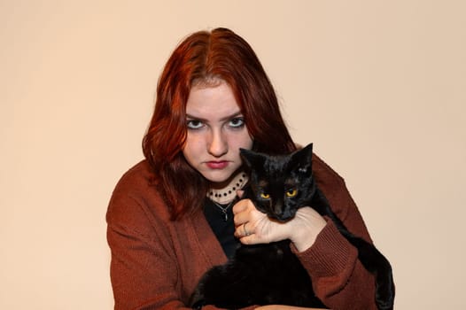 A girl with her black cat and white background