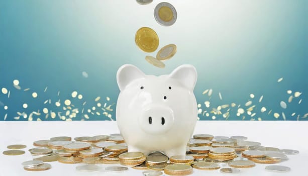 Coins falling to white piggy saving , Financial and money deposit concept.