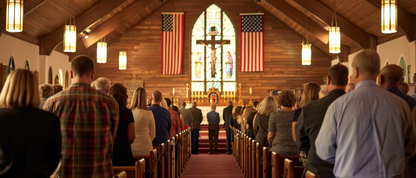 Parishioners stand respectfully in a church adorned with an American flag, engaged in a service that blends faith with patriotism under the watchful gaze of stained glass saints