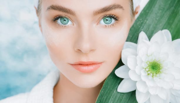 Portrait of beautiful woman with healthy glow perfect smooth skin holds tropical leaf, look into the hole of green paper. Young girl enjoys cream facial mask. Fashion, beauty, skincare concept.