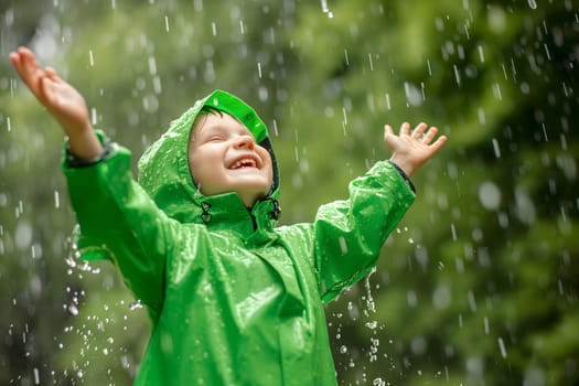 Happy child in green raincoat enjoying rain. Neural network generated image. Not based on any actual person or scene.