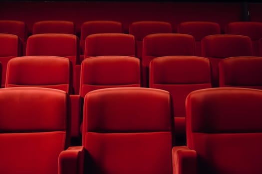 Empty red seats in cinema, domestic intimacy, zoom in, up close. Neural network generated in January 2024. Not based on any actual scene or pattern.