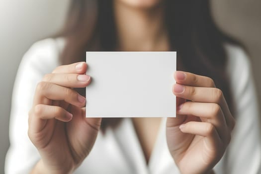 Long-haired young adult Caucasian woman Hand holding blank business card on white background. Neural network generated image. Not based on any actual scene or pattern.