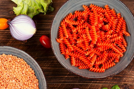 Dry red lentil fusilli pasta. Uncooked vegan pasta. Gluten free pasta.