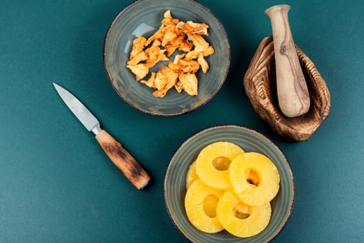 Dried tasty pineapples or ananas in bowls. Candy pineapples.