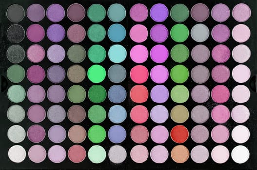 Multi-colored large professional set for face and eye makeup close-up. Texture or background