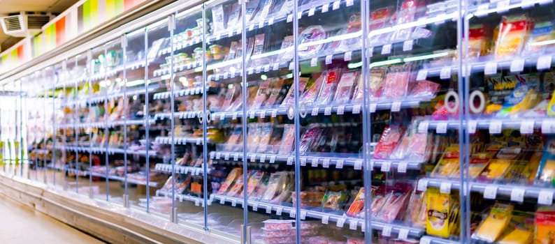 LEUVEN, BELGIUM - AUG 26, 2022: Food products displayed in a commercial refrigerator in supermarket