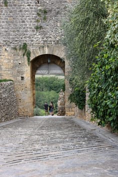 Monteriggioni, Italy - Sept 17, 2022: Porta Fiorentina city gate in Monteriggioni medieval walled town near Siena in Tuscany, Italy
