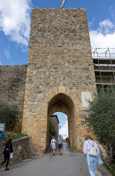 Monteriggioni, Italy - Sept 17, 2022: Porta Franca, city gate in Monteriggioni medieval walled town near Siena in Tuscany, Italy