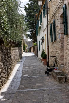 Monteriggioni, Italy - Sept 17, 2022: Picturesque street in Monteriggioni medieval walled town near Siena in Tuscany, Italy