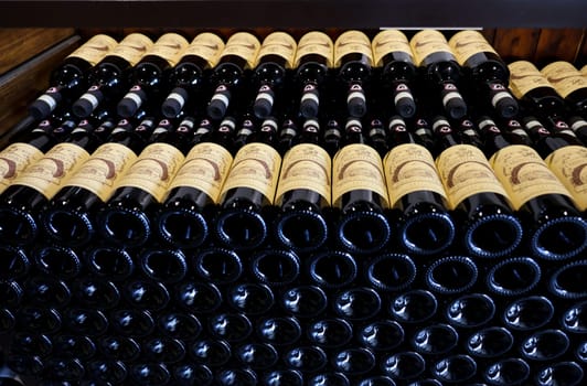 Monteriggioni, Italy - Sept 17, 2022: Neatly arranged bottles of Chianti Classico wine in a wine shop in Monteriggioni near Siena. Italy