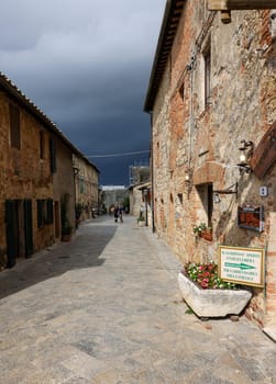 Monteriggioni, Italy - Sept 17, 2022: Picturesque street in Monteriggioni medieval walled town near Siena in Tuscany, Italy