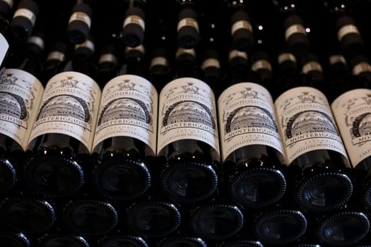 Monteriggioni, Italy - Sept 17, 2022: Neatly arranged bottles of Chianti Classico wine in a wine shop in Monteriggioni near Siena. Italy