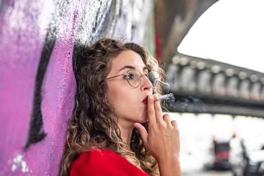 pensive young woman with cigarette