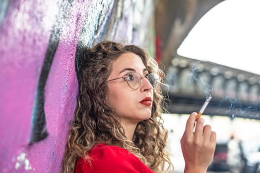 pensive young woman with cigarette
