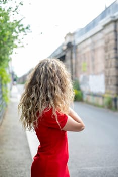 lonely young woman standing on the street