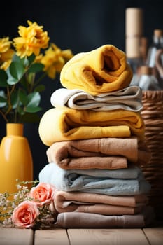 Stacked towels after washing with bright yellow flowers create a feeling of coziness and calm.