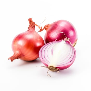 A group of red onions, one cut in half to reveal the layers, on a clean white background.