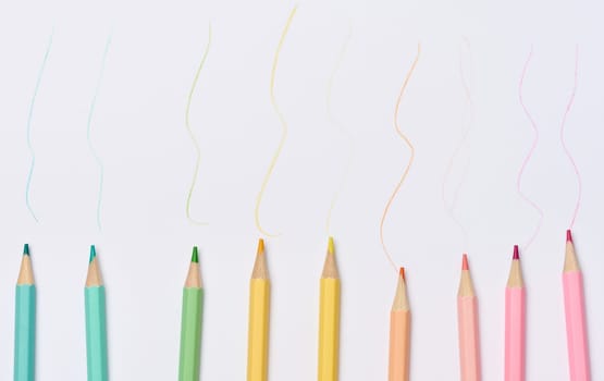 Multi-colored wooden pencils on a white background