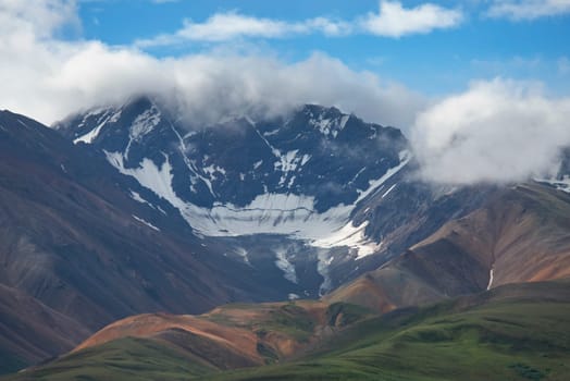 Alaska Landscape with Snowy Mountains and Cloudy sky.