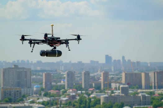 Copter drone carrying a bombshell above city at summer day. Neural network generated image. Not based on any actual scene or pattern.