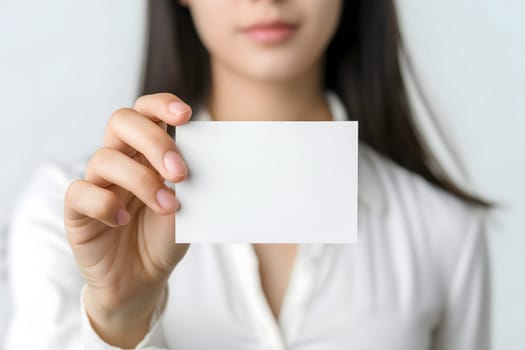 Long-haired young adult Caucasian woman Hand holding blank business card on white background. Neural network generated image. Not based on any actual scene or pattern.