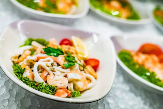 Seafood salad plates displayed in a commercial restaurant refrigerator