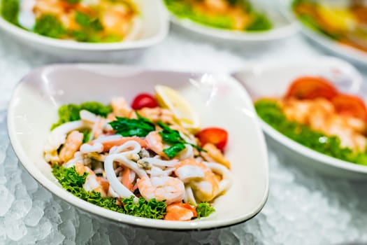 Seafood salad plates displayed in a commercial restaurant refrigerator