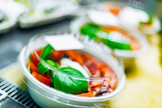 Pre-packaged ready to eat meals displayed in a commercial refrigerator