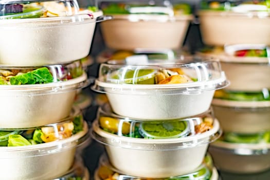 Pre-packaged ready to eat meals displayed in a commercial refrigerator