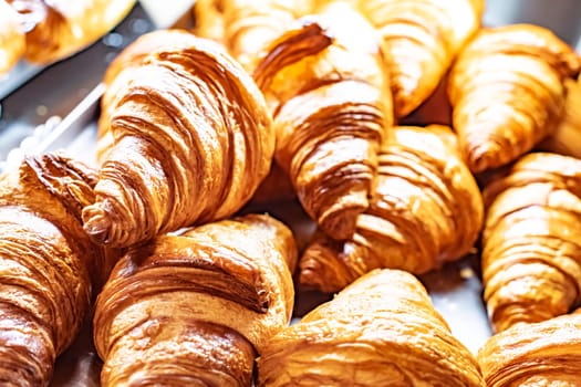 Fresh croissants sold in a bakery store.