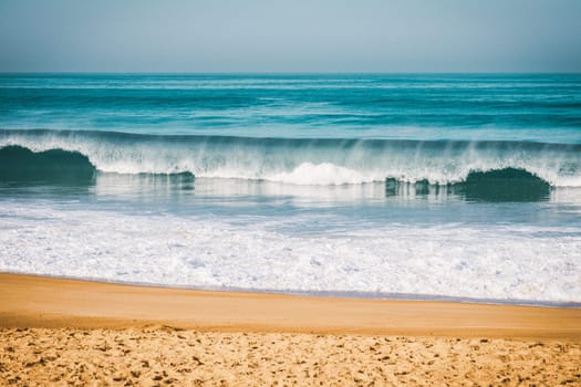 Wave breaking to the beach on  the coast in Brittany, intentionnal grain