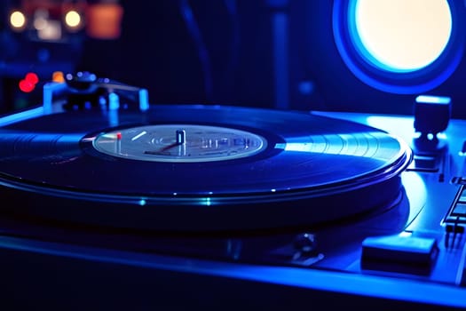 Close-up of a record player in blue light