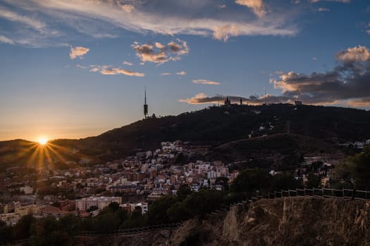 Sunset view of the mountains surrounding Barcelona in Spain with the silhouette of the enormous Collserola telecommunications tower dominating the entire Barcelona plain. In addition to its view of the city, the hill is known for its natural spaces used for recreational purposes.