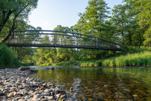 View of the water of the Eder River in Germany, from the bank with a bridge