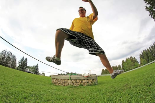 A young man balances on a slackline