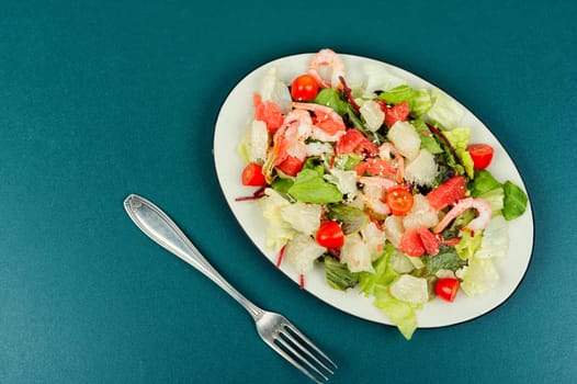 Tasty salad with pomelo, shrimps and greens. Thai appetizer salad.