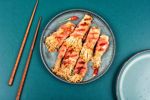 Bacon rolls stuffed with enoki mushroom. Bacon wrapped mushroom. Flat lay with copy space.