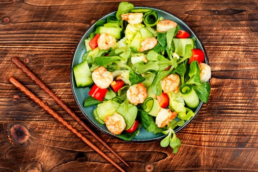 Plate with shrimps salad with green lettuce. Salad of shrimp or prawns. Healthy eating.