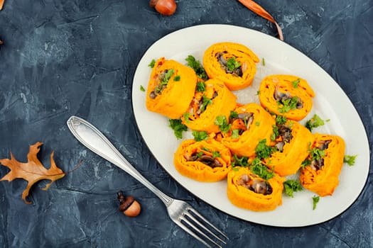 Delicious pumpkin dough rolls stuffed with mushrooms on vintage table.
