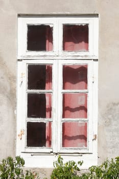 Old, white wooden window on a white house wall, Germany