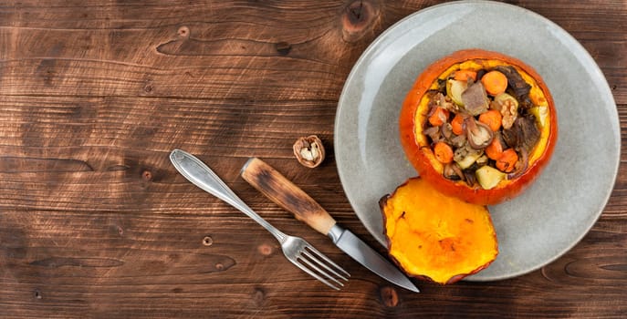 Autumn roasted pumpkin stuffed with beef meat, mushrooms, apple and carrots.
