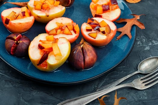 Tasty baked halves autumn apples and figs, fruit dessert.
