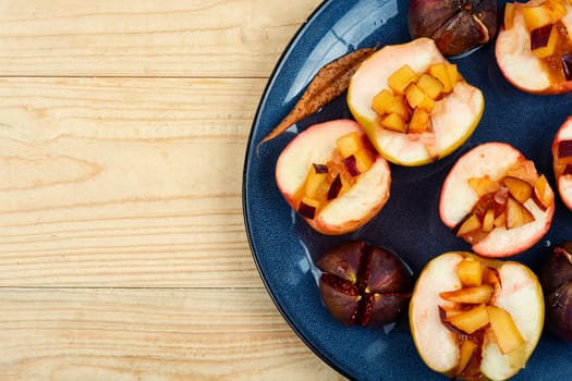 Tasty baked halves autumn apples and figs, fruit dessert.