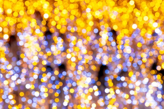 Gleaming golden bokeh lights abstract festive background with shiny glitter texture and bright sparkle illumination
