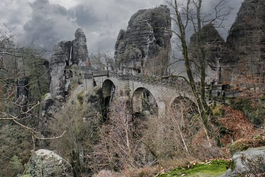 The Bastei Bridge in Saxon Switzerland. jagged rocks, viewing platform overlooking the Elbe. Tourist attraction. Dramatic sky. National park in Germany