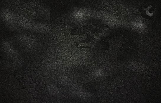The background texture of a rough monochrome surface with spots and irregularities